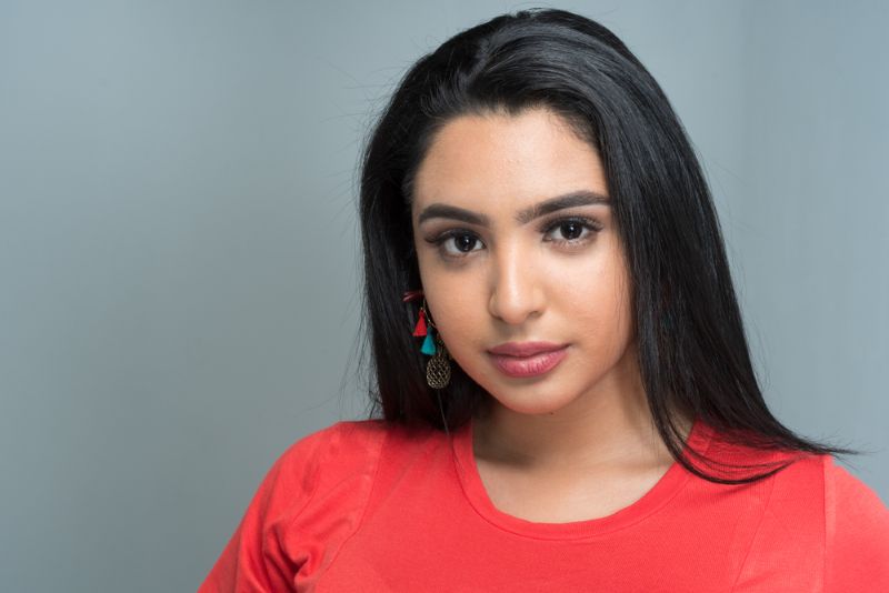 young hispanic woman wearing red