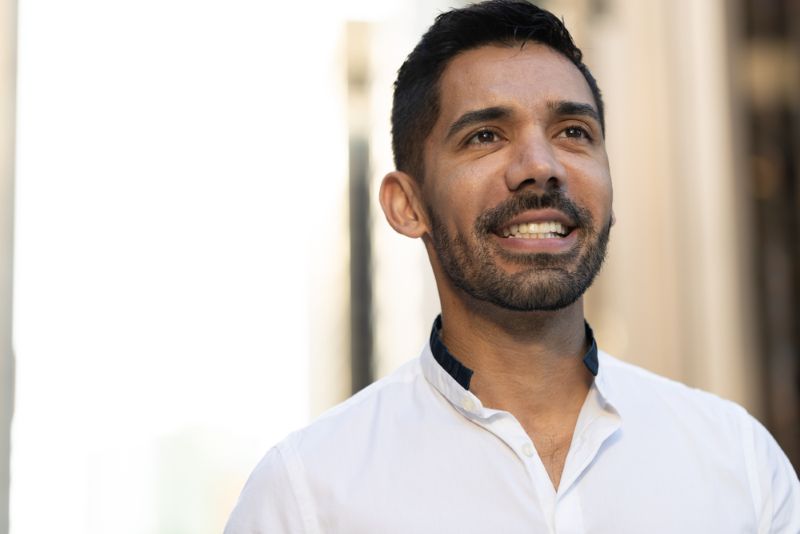 young immigrant man smiling